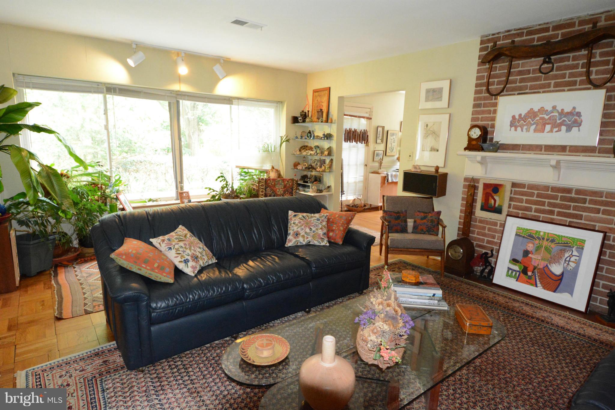 8605 Springdell Place Chevy Chase, MD 20815 - Photo 13 of 15 a living room with furniture and a fireplace
