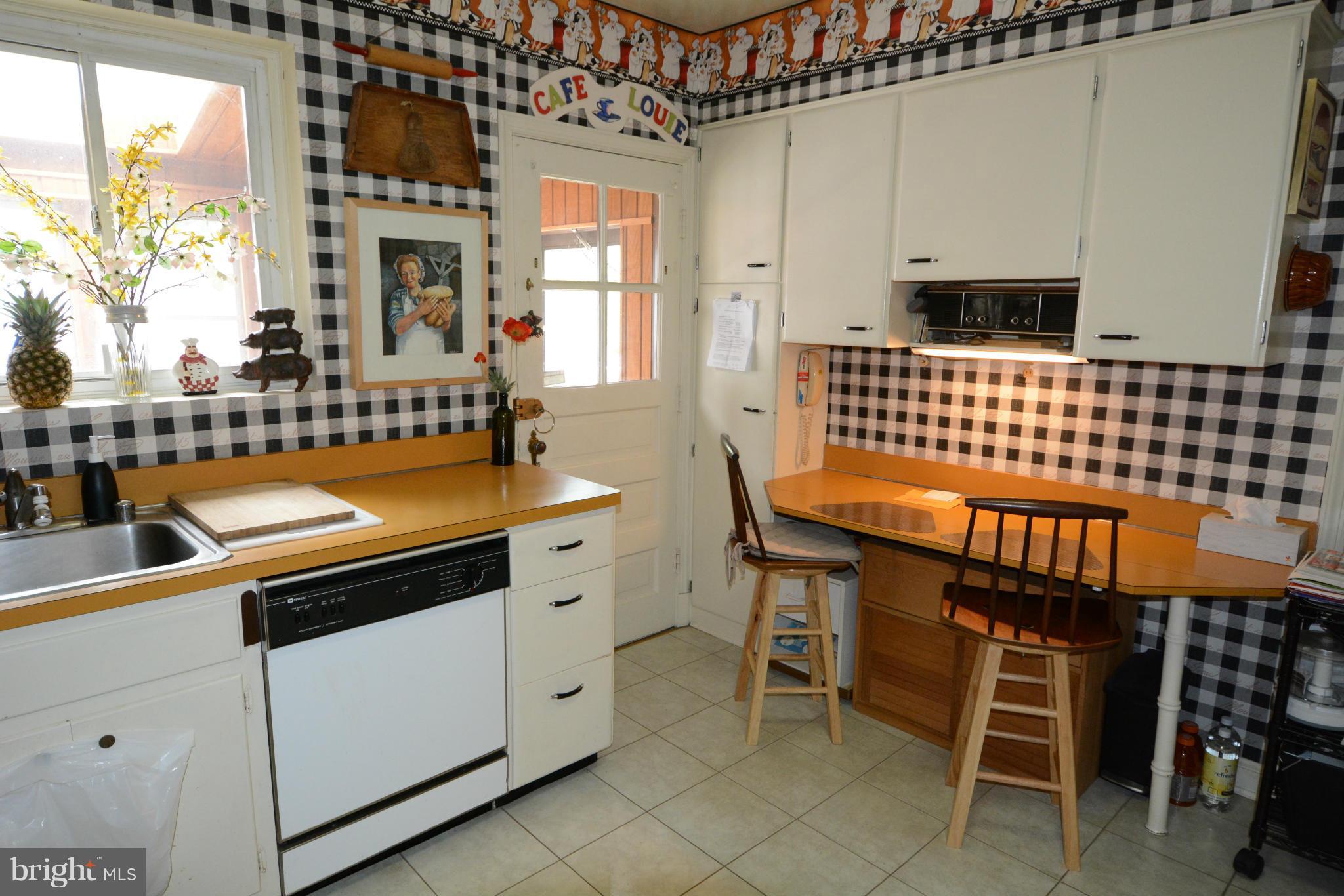 8605 Springdell Place Chevy Chase, MD 20815 - Photo 6 of 15 a kitchen with a sink and cabinets