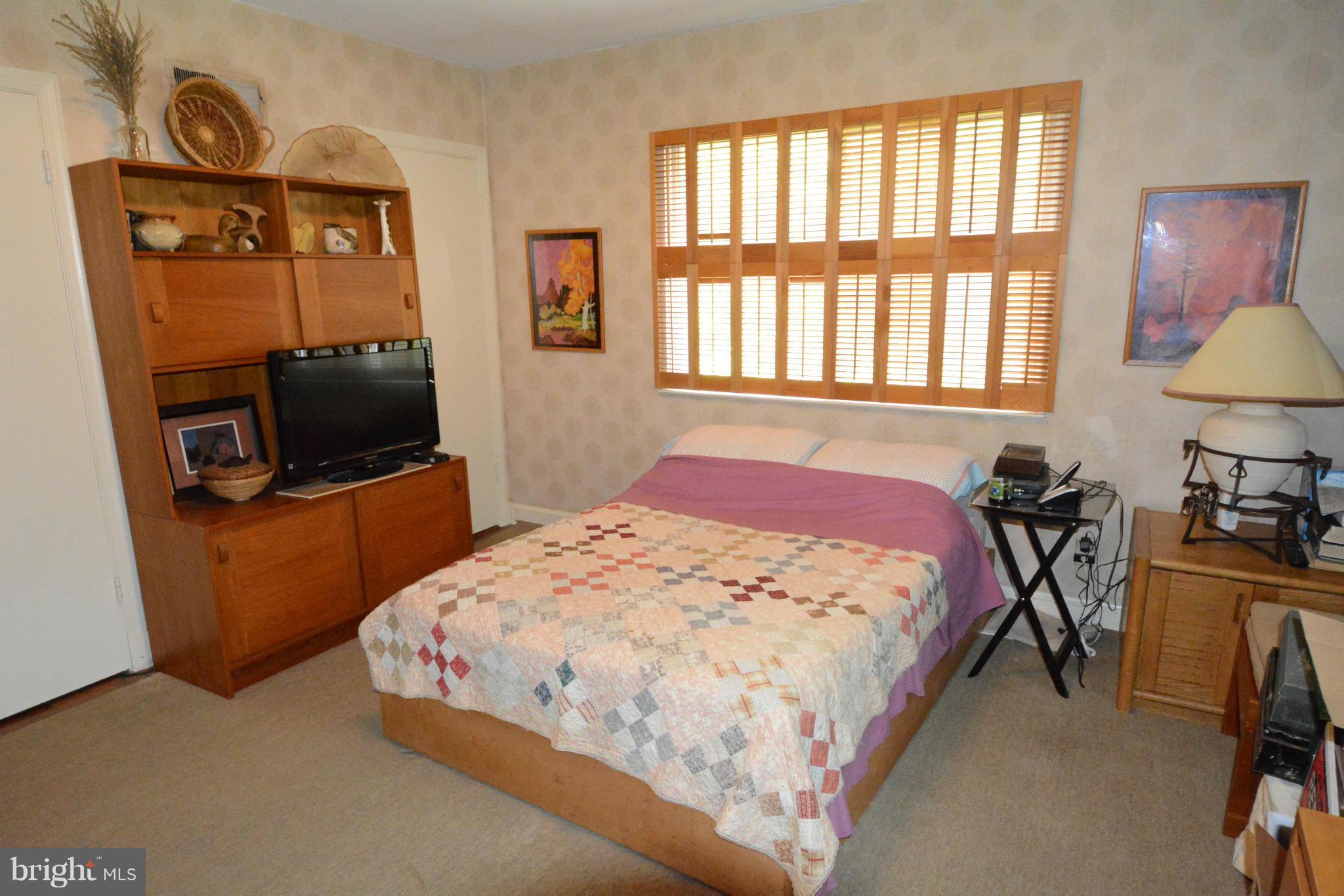 8605 Springdell Place Chevy Chase, MD 20815 - Photo 8 of 15 a bedroom with a bed a television and a window