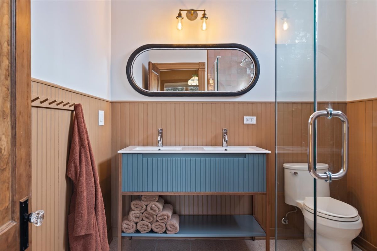 1328 West Byron Street Chicago, IL 60613 - Photo 16 of 40 a bathroom with a toilet a sink and a mirror