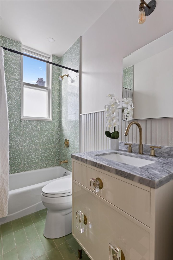 1328 West Byron Street Chicago, IL 60613 - Photo 18 of 40 a bathroom with a sink a toilet and shower