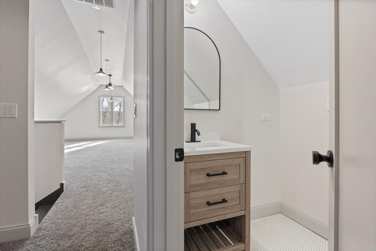 1328 West Byron Street Chicago, IL 60613 - Photo 26 of 40 a bathroom with a sink a vanity and a mirror