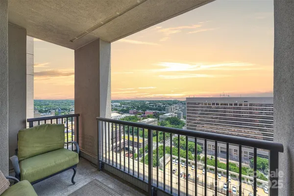 a view of a balcony with furniture