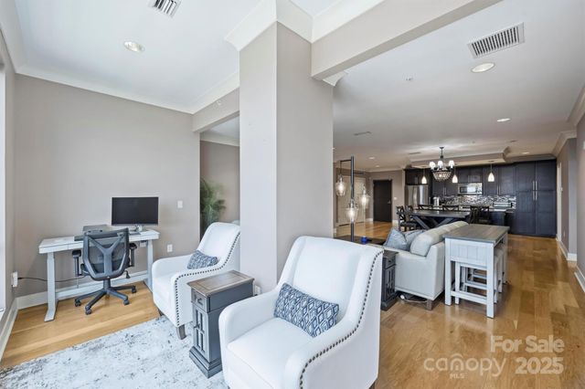 a living room with furniture and a dining table with kitchen view