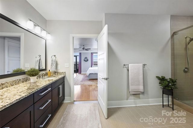 a spacious bathroom with a granite countertop sink and a mirror