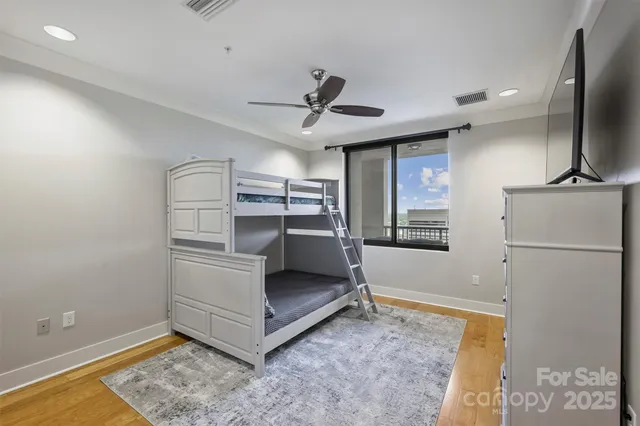 a living room with stainless steel appliances kitchen island granite countertop furniture and a rug