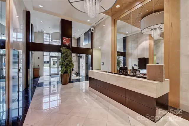 a large white kitchen with a counter top space and stainless steel appliances