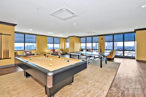 a large dining hall with stainless steel appliances granite countertop a stove top oven a sink and a counter space