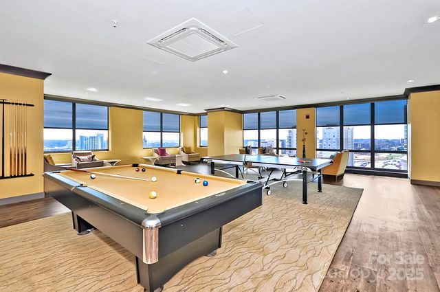 a large dining hall with stainless steel appliances granite countertop a stove top oven a sink and a counter space