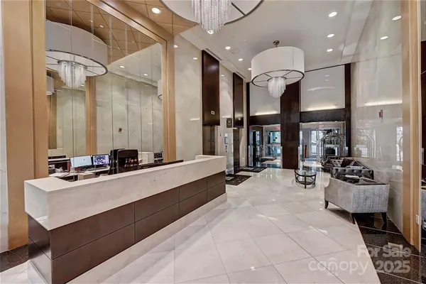 a large white kitchen with a large window and stainless steel appliances