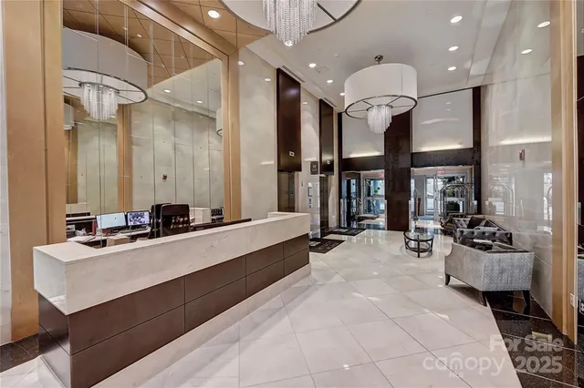 a large white kitchen with a large window and stainless steel appliances