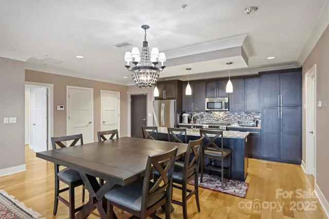 a view of a dining room with furniture and chandelier