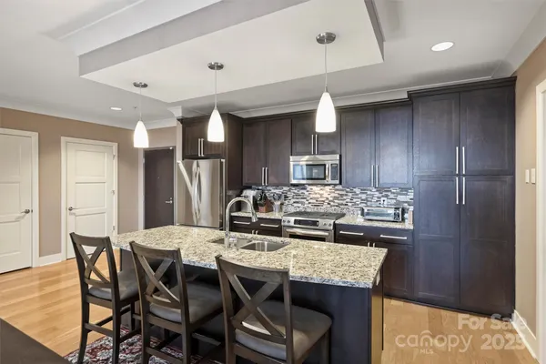 a kitchen with a table and chairs in it