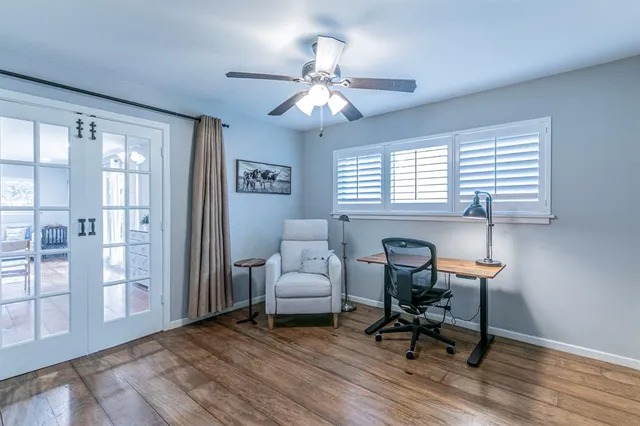 a workspace with wooden floor and a window