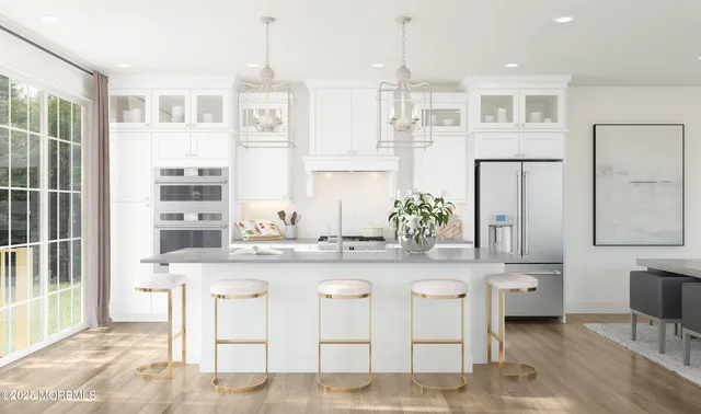 a large kitchen with kitchen island granite countertop a sink and cabinets
