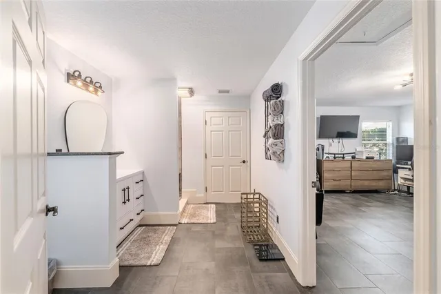 a view of a bedroom with tub and mirror