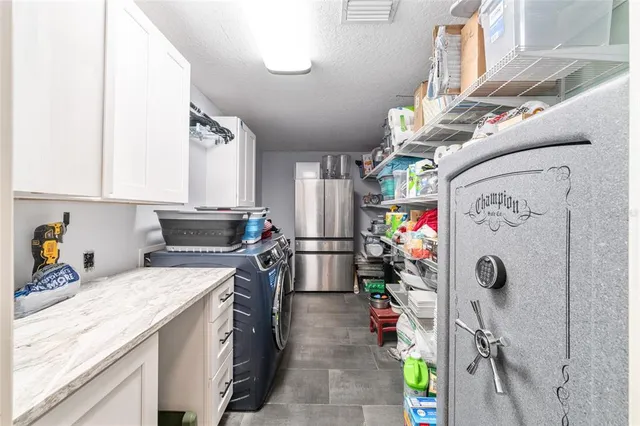 a kitchen with stainless steel appliances granite countertop a refrigerator and a stove