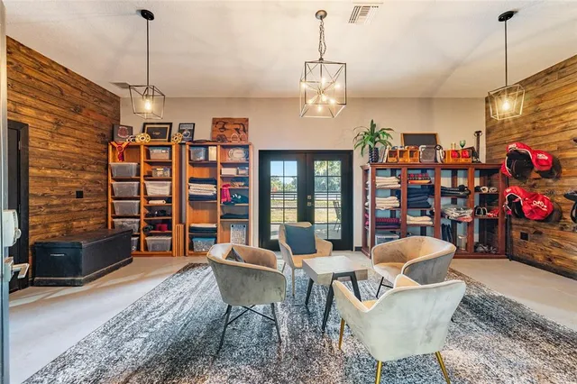 a living room with furniture a rug and a chandelier