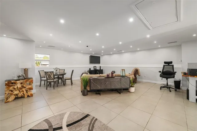 a living room with furniture a rug and a table