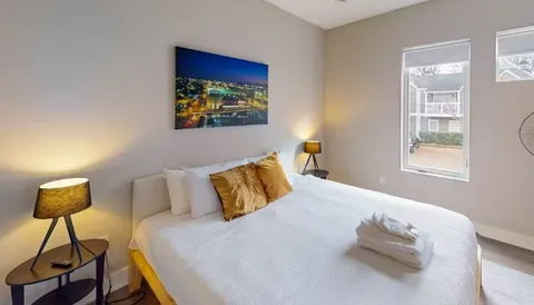 a bedroom with a bed and a window