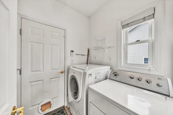 a spacious bedroom with a bed and a chandelier