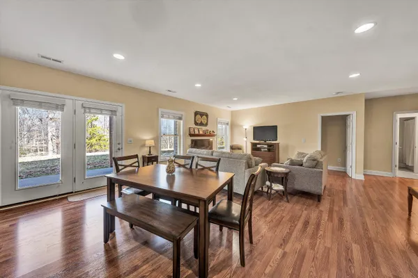 a kitchen with granite countertop a stove and wooden floor