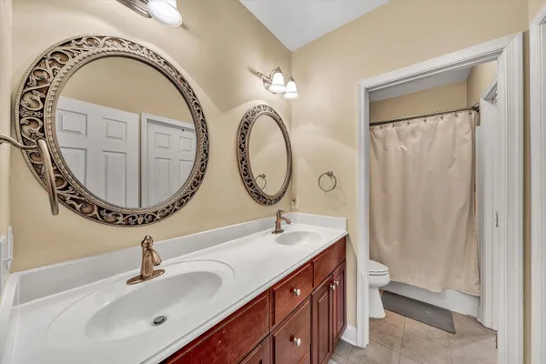 a view of a bathroom with sink mirror and window