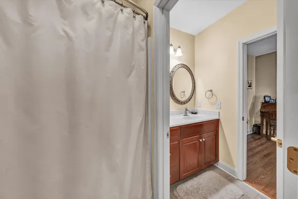 a bathroom with a granite countertop toilet a sink and a mirror