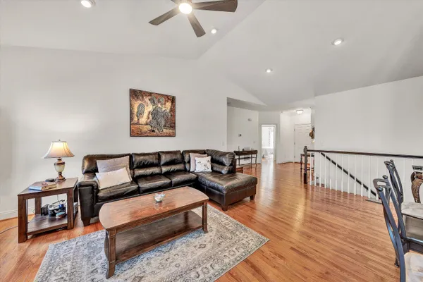 a large kitchen with stainless steel appliances granite countertop a stove a sink dishwasher a refrigerator and a microwave oven with large wooden cabinets