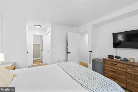 a bedroom with a bed and a flat screen tv