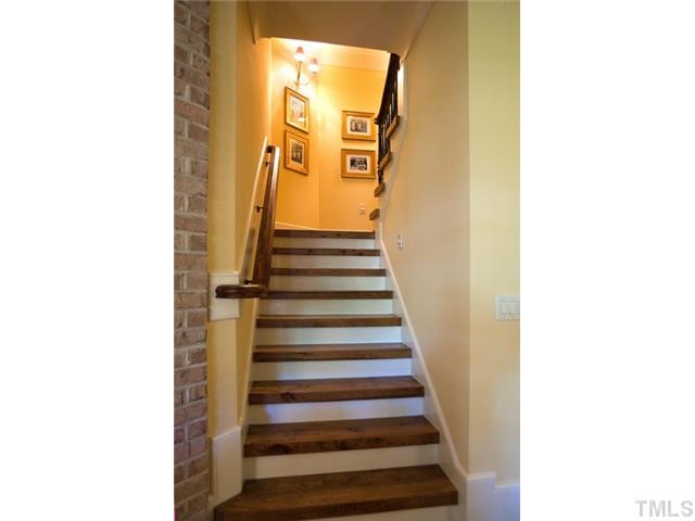 3026 Churchill Road Raleigh, NC 27607 - Photo 8 of 25 Staircase with treads made from a pecan tree reclaimed from the lot.