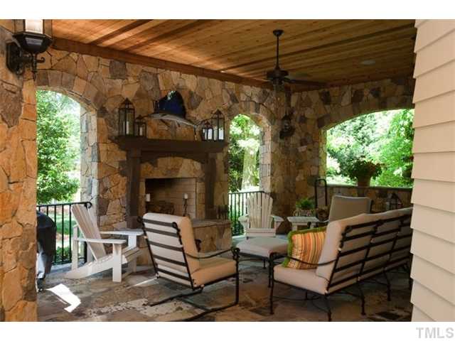 3026 Churchill Road Raleigh, NC 27607 - Photo 9 of 25 Outdoor living area features flagstone floor, veneer stone arches, rough sawn western red cedar tongue and groove ceiling, natural gas line for grill, wood burning fireplace with gas log lighter.