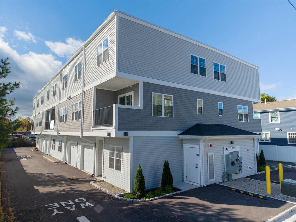 889-895 Grinnell Street, Unit 2 Fall River, MA 02721 - Photo 2 of 38 a front view of a building with a lot of windows