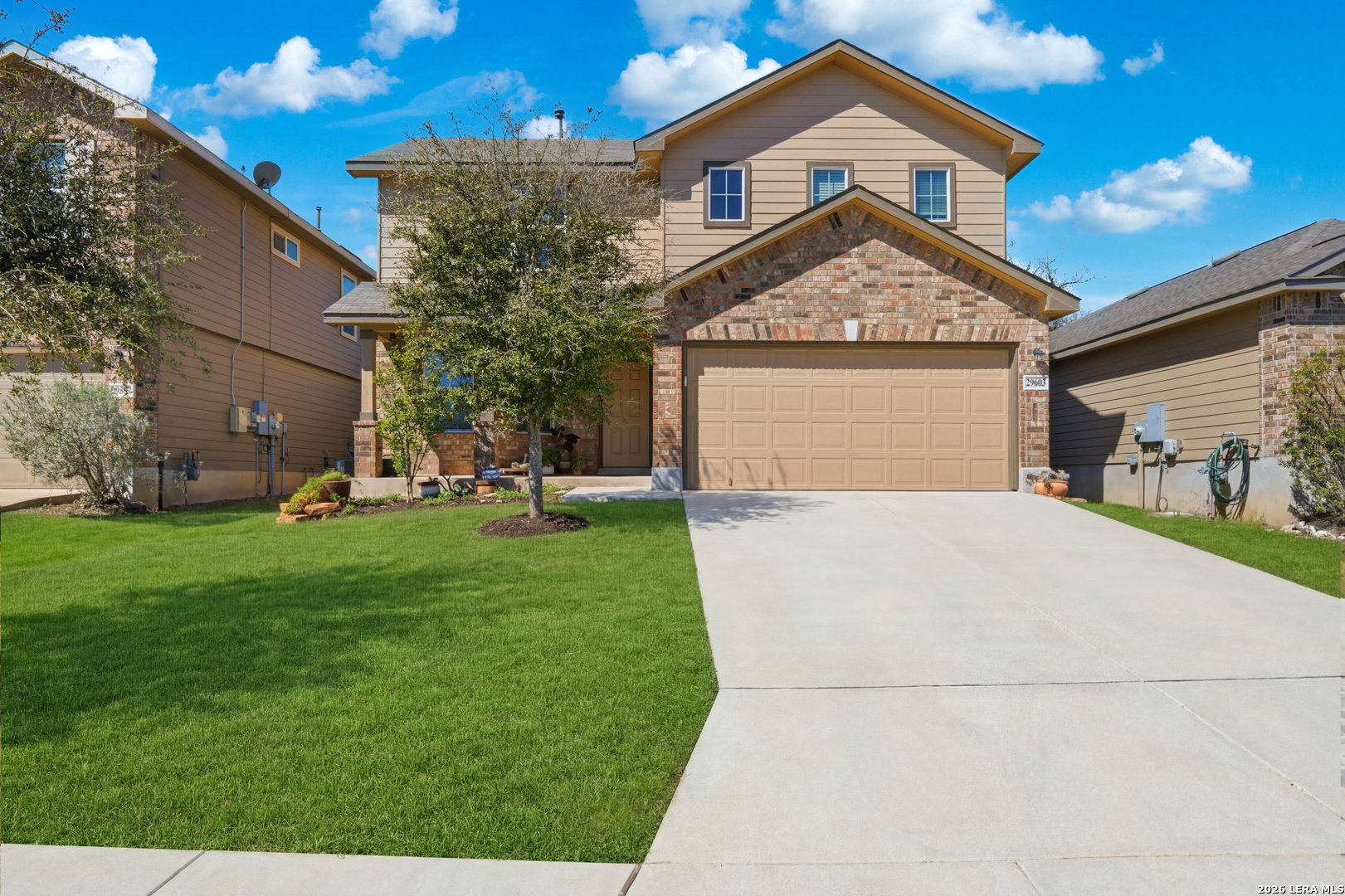 a front view of a house with a yard and garage