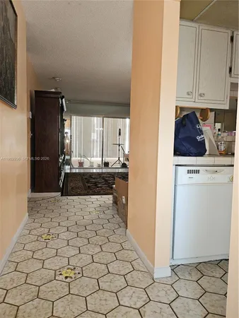 a kitchen with granite countertop white cabinets and stainless steel appliances
