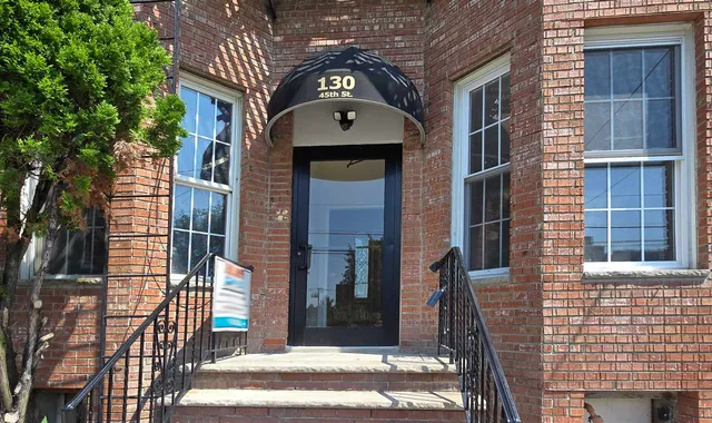 a view of a brick house with many windows