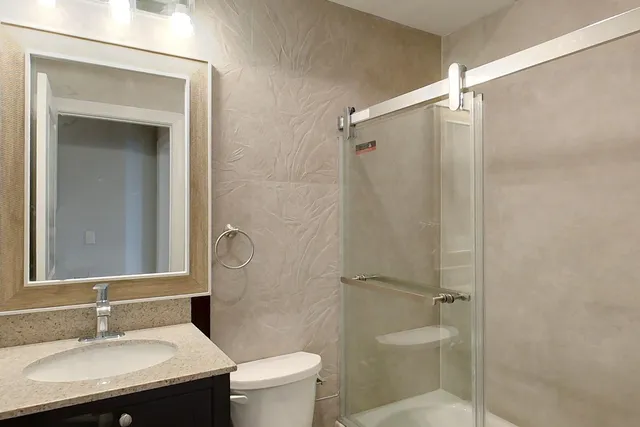 a bathroom with a sink toilet and shower