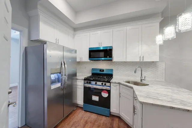 a kitchen with a refrigerator sink and microwave
