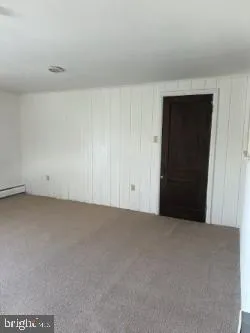 a view of a room with window and hardwood floor