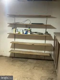a view of an empty room with wooden shelves