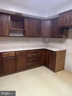 a kitchen with a refrigerator and cabinets