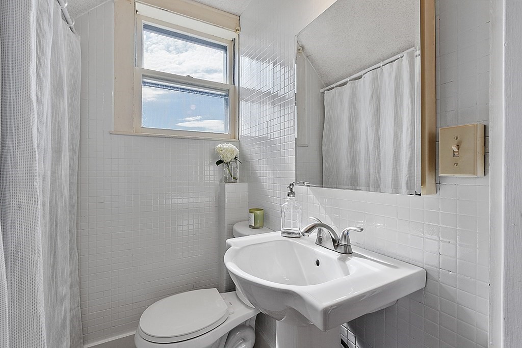 70 Park Avenue Stoneham, MA 02180 - Photo 23 of 36 a bathroom with a sink a toilet and shower