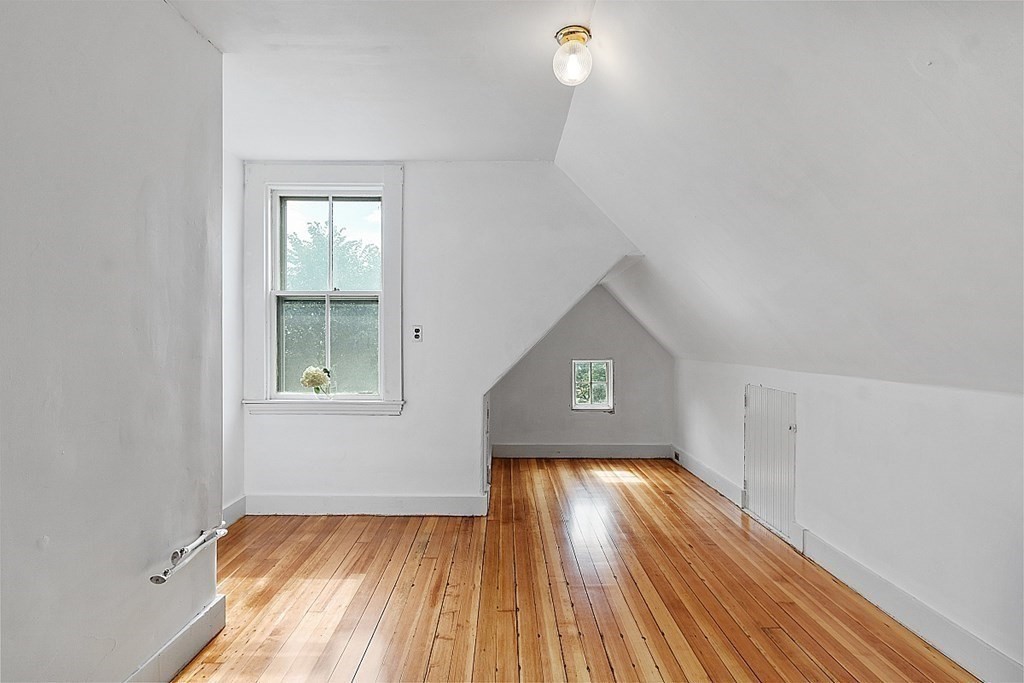70 Park Avenue Stoneham, MA 02180 - Photo 25 of 36 an empty room with wooden floor and windows