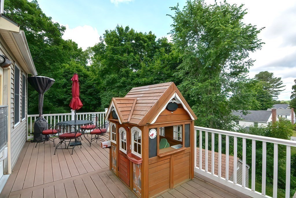 70 Park Avenue Stoneham, MA 02180 - Photo 27 of 36 a view of a wooden deck and a yard with wooden fence and floor