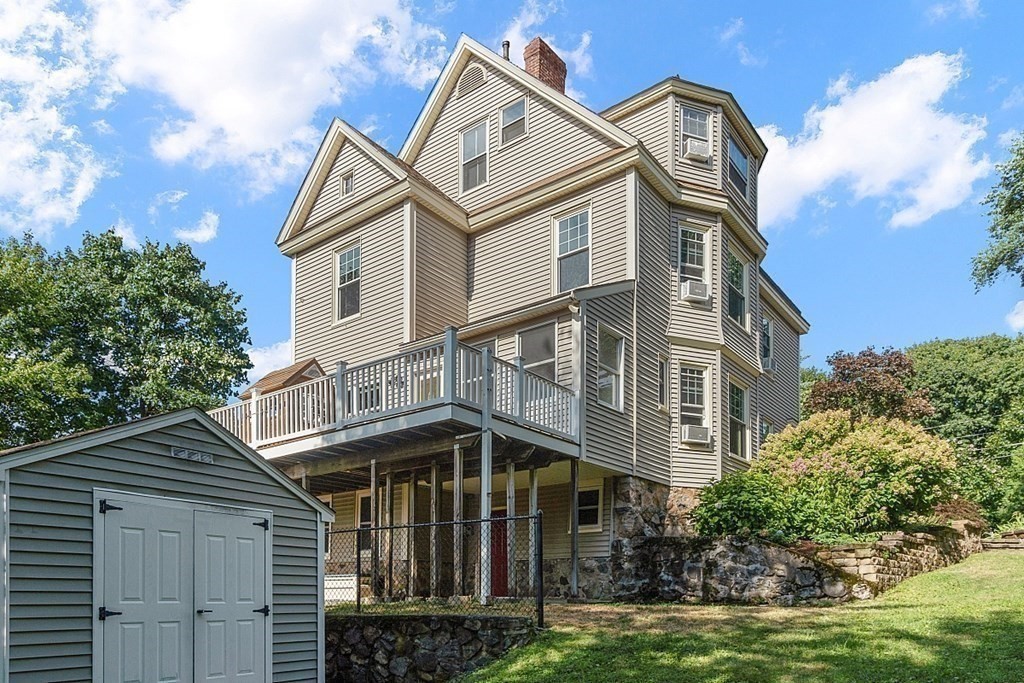 70 Park Avenue Stoneham, MA 02180 - Photo 32 of 36 a view of a house with a small yard and large trees