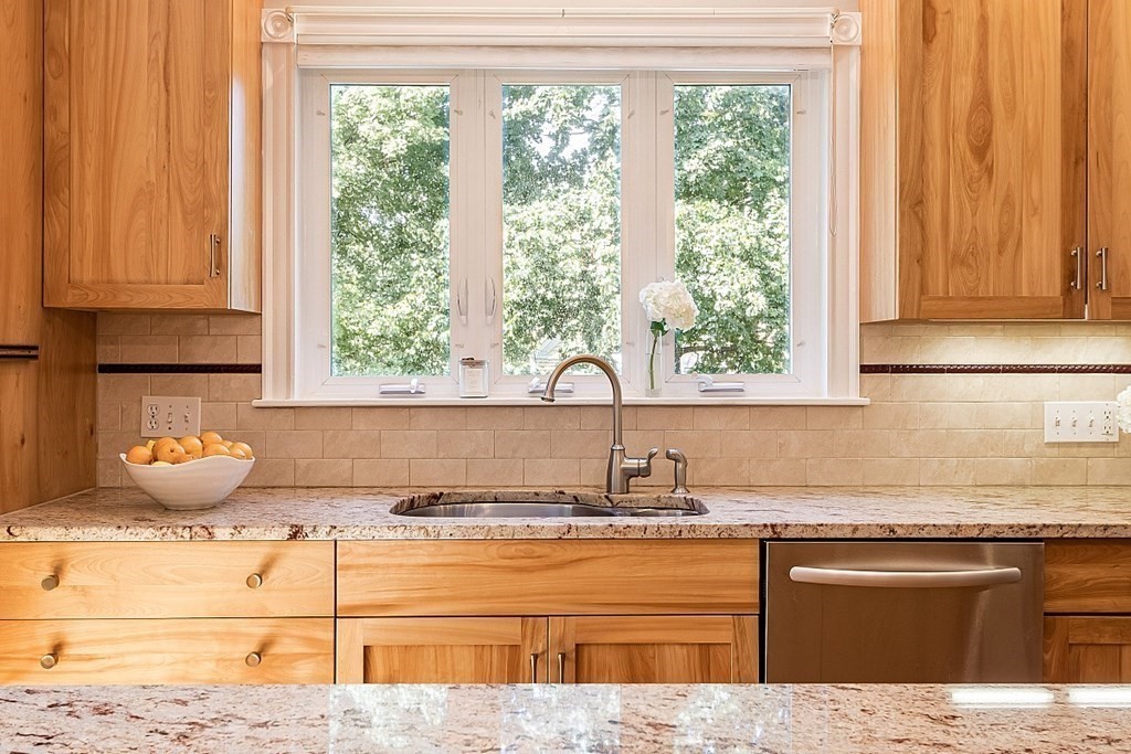 70 Park Avenue Stoneham, MA 02180 - Photo 7 of 36 a kitchen with granite countertop a sink and a window