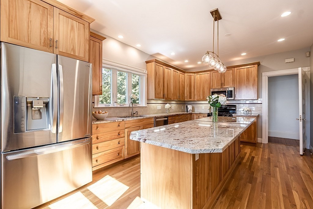 70 Park Avenue Stoneham, MA 02180 - Photo 8 of 36 a kitchen with stainless steel appliances granite countertop a sink a stove and refrigerator