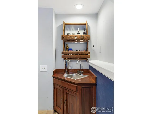 a room with a sink and a mirror