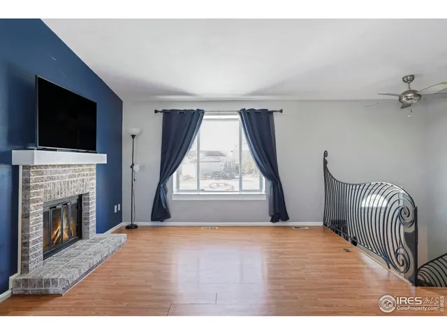 a view of empty room with fireplace and windows