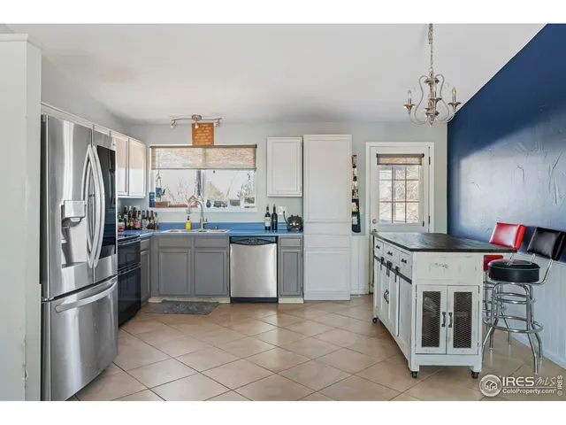 a kitchen with stainless steel appliances a refrigerator sink and cabinets